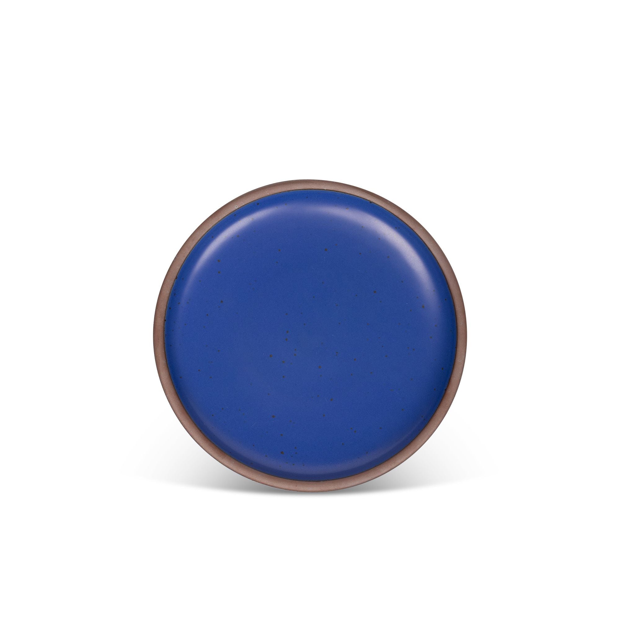 A medium sized ceramic plate in a cobalt blue color featuring iron speckles and an unglazed rim.