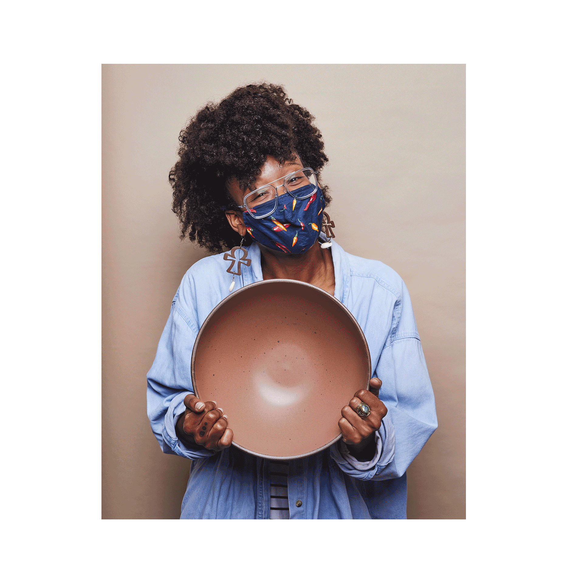 A gif featuring a person in a denim shirt holding a large bowl in a warm brown color