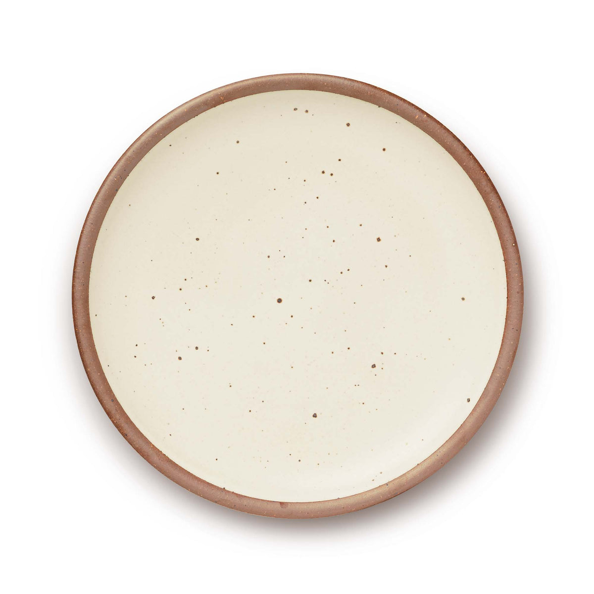 A large ceramic platter in a warm off-white color featuring iron speckles and an unglazed rim.