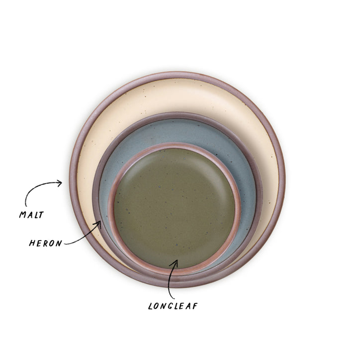 A trio of nesting plates in cream, blue-grey, and olive green colors.