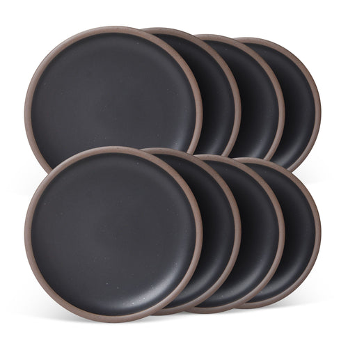 8 medium sized ceramic plates in a graphite black color featuring iron speckles and an unglazed rim.