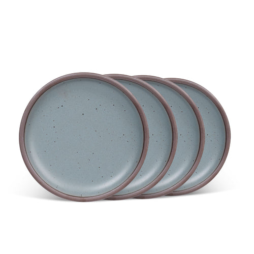 4 medium sized ceramic plates in a blue-grey color featuring iron speckles and an unglazed rim.