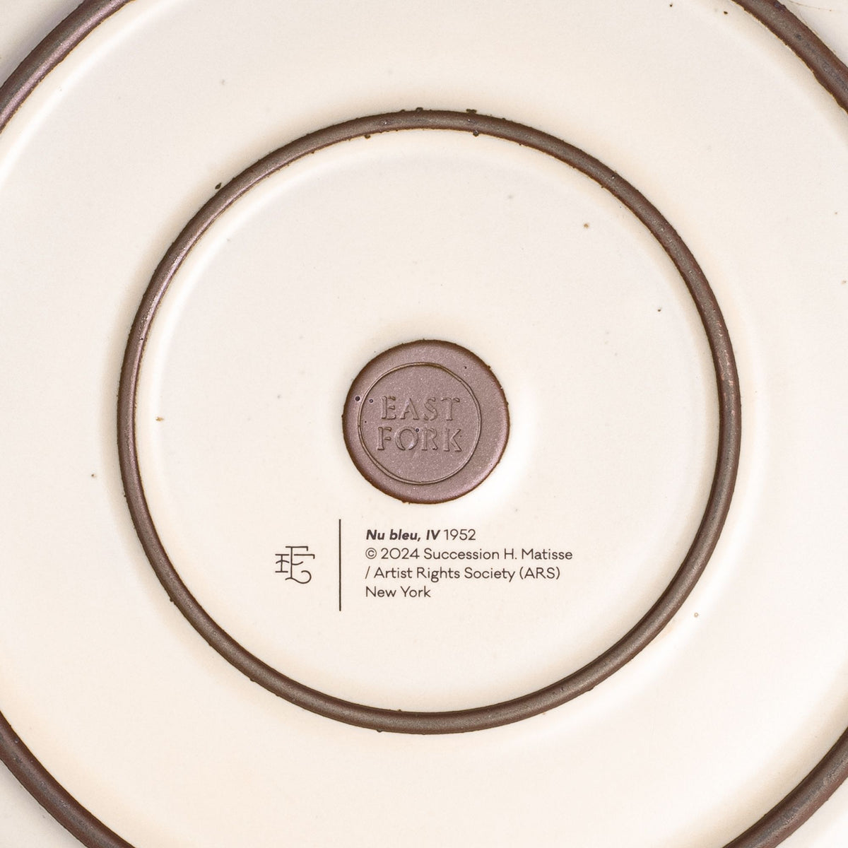 The back of the Dinner Platter with an East Fork stamp with a small decal of information about the artwork.