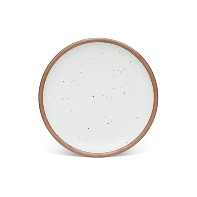 A dinner sized ceramic plate in a cool white color featuring iron speckles and an unglazed rim.