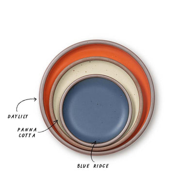 A stack of 3 plates in Dinner, Side, and Cake sizes in a bold orange, cream, and cool medium blue colors.