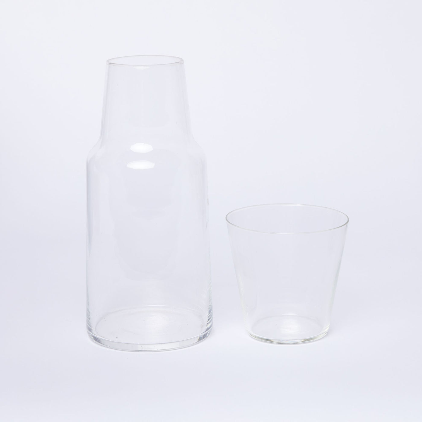 Clear carafe with clear glass next to it
