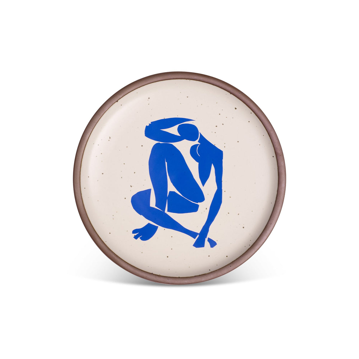 A plate featuring Nu Bleu IV, by Henri Matisse, a bright blue, abstract, silhouetted female figure in a curled, seated position, with sharp cut-out edges, centered on an off-white ceramic plate with an unglazed rim.