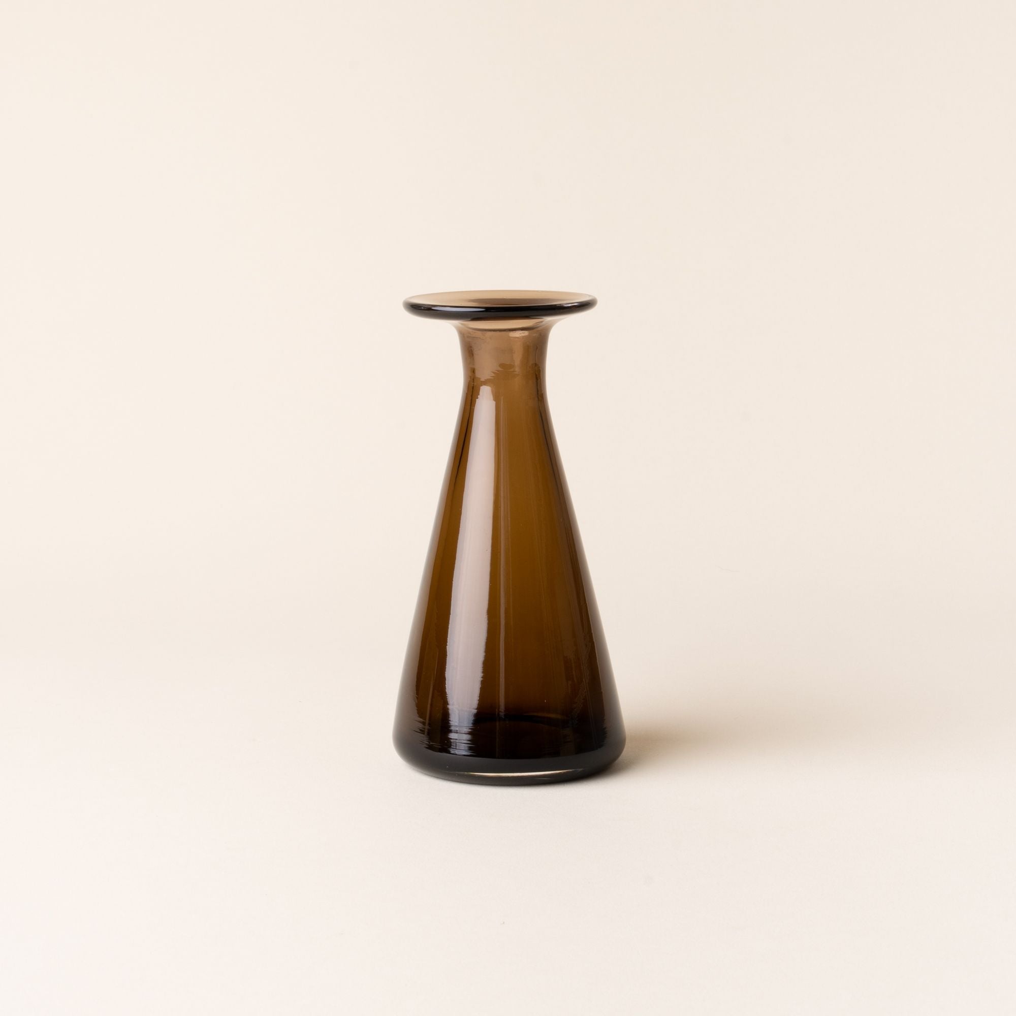Brown glass vase with a flared rim and tapered base, standing upright against a neutral background.