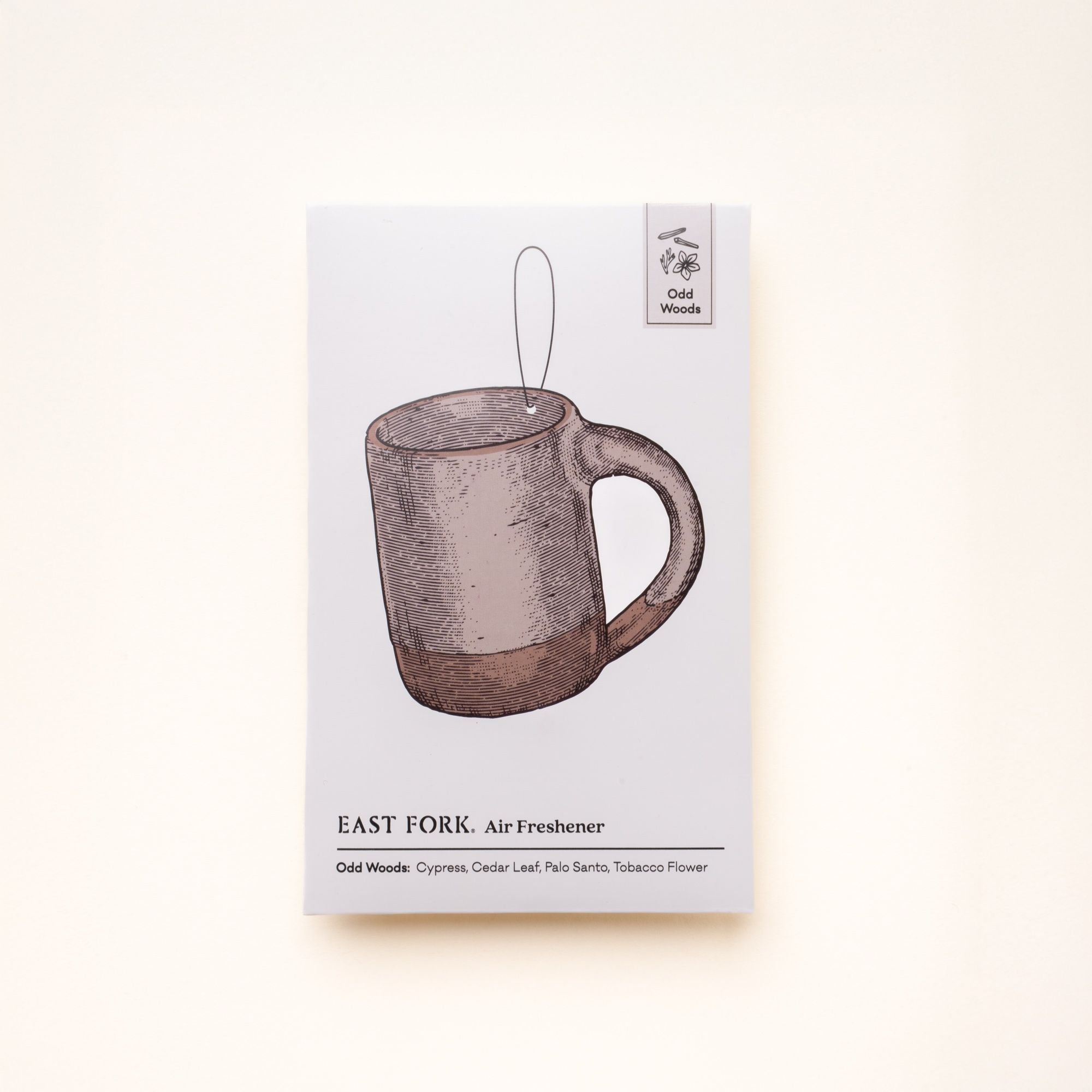 East Fork “Odd Woods” air freshener packaging featuring an illustrated mug and scent notes of cypress, cedar leaf, palo santo, and tobacco flower.