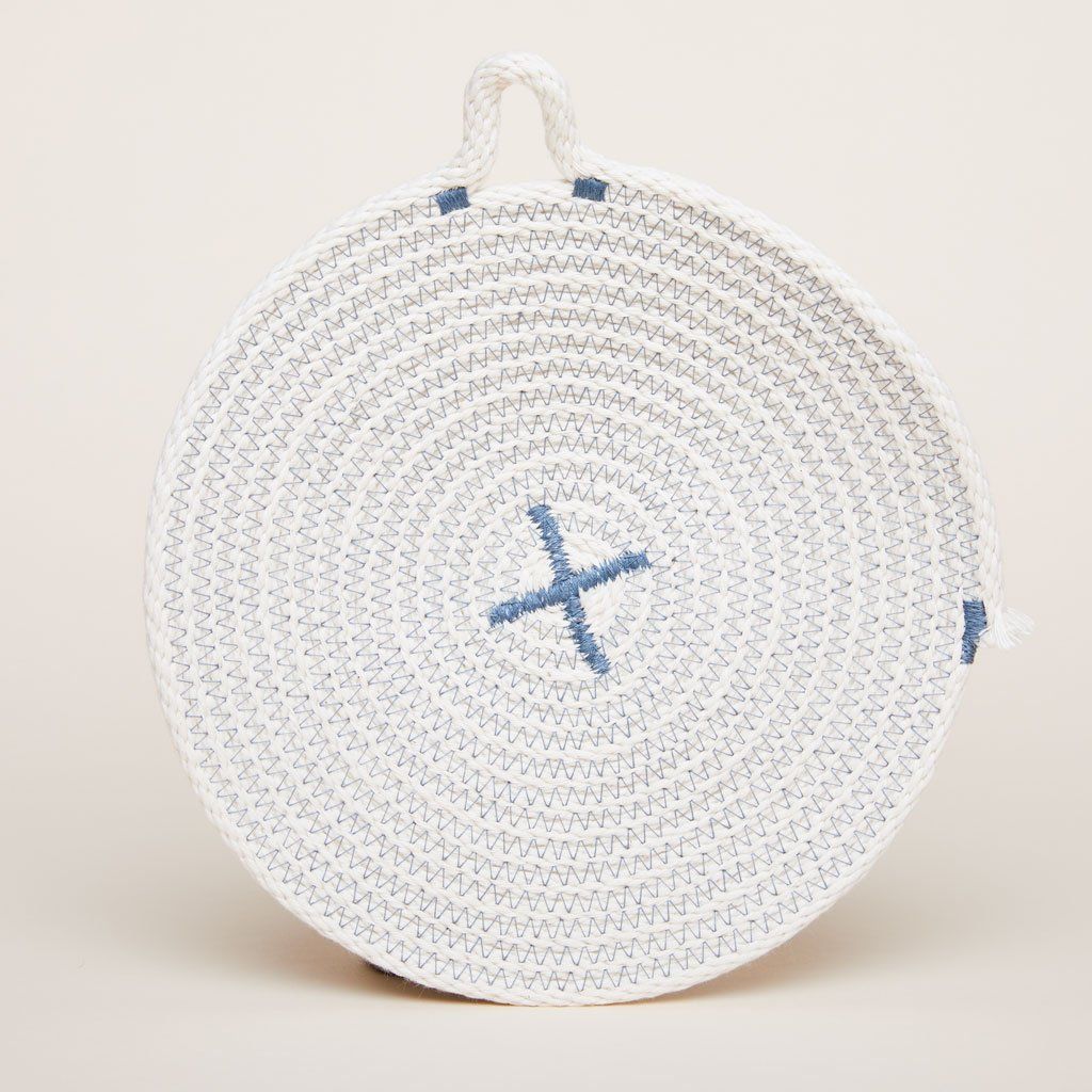 Blue thread on a beige trivet