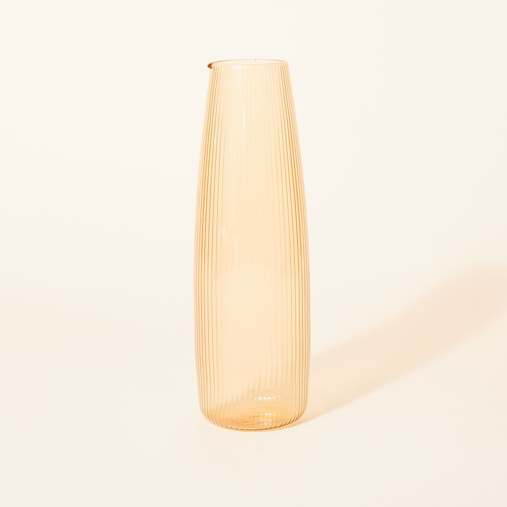 A tall, pale yellow pitcher with a spout at the rim