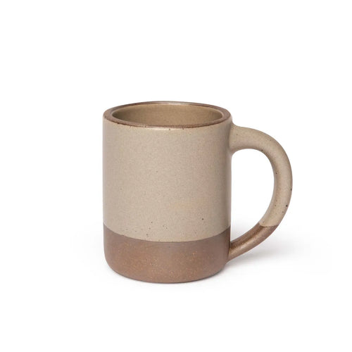 A big sized ceramic mug with handle in a pale warm brown glaze featuring iron speckles and unglazed rim and bottom base.