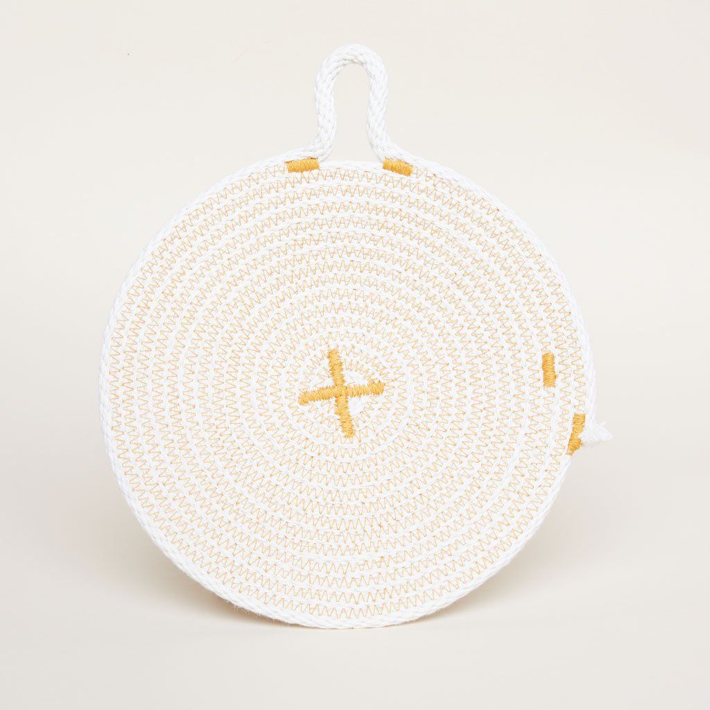 Beige trivet with yellow trim